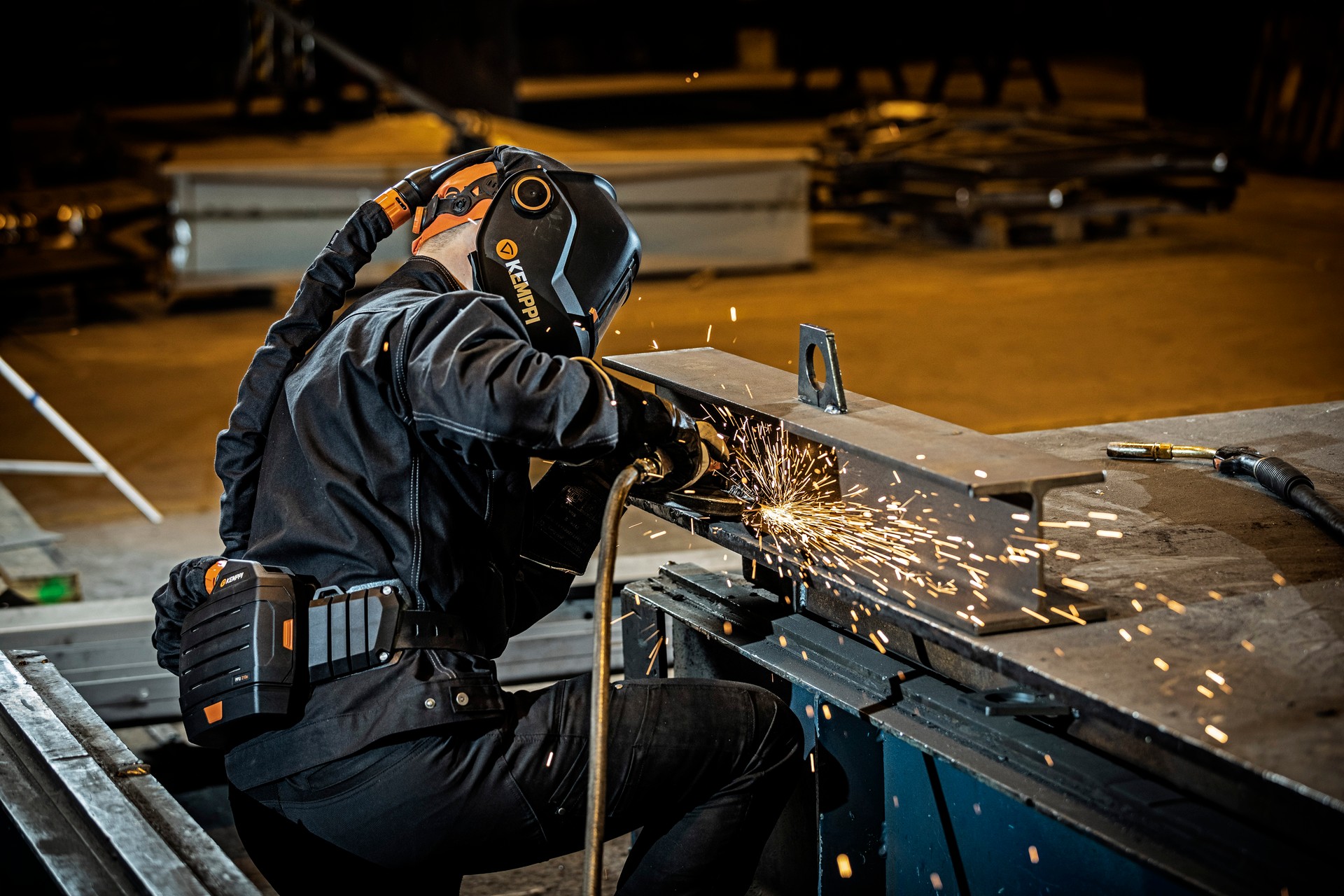 A welder grinding