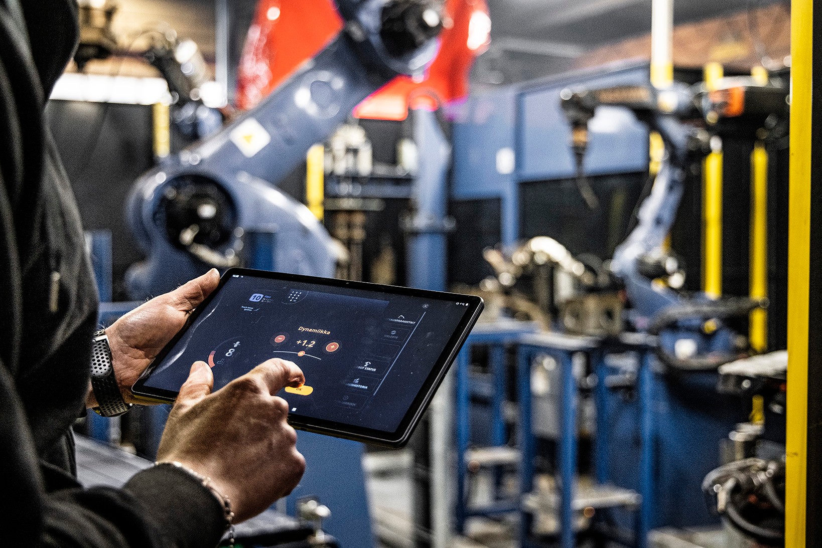 Welding robot operator setting parameters with mobile pad