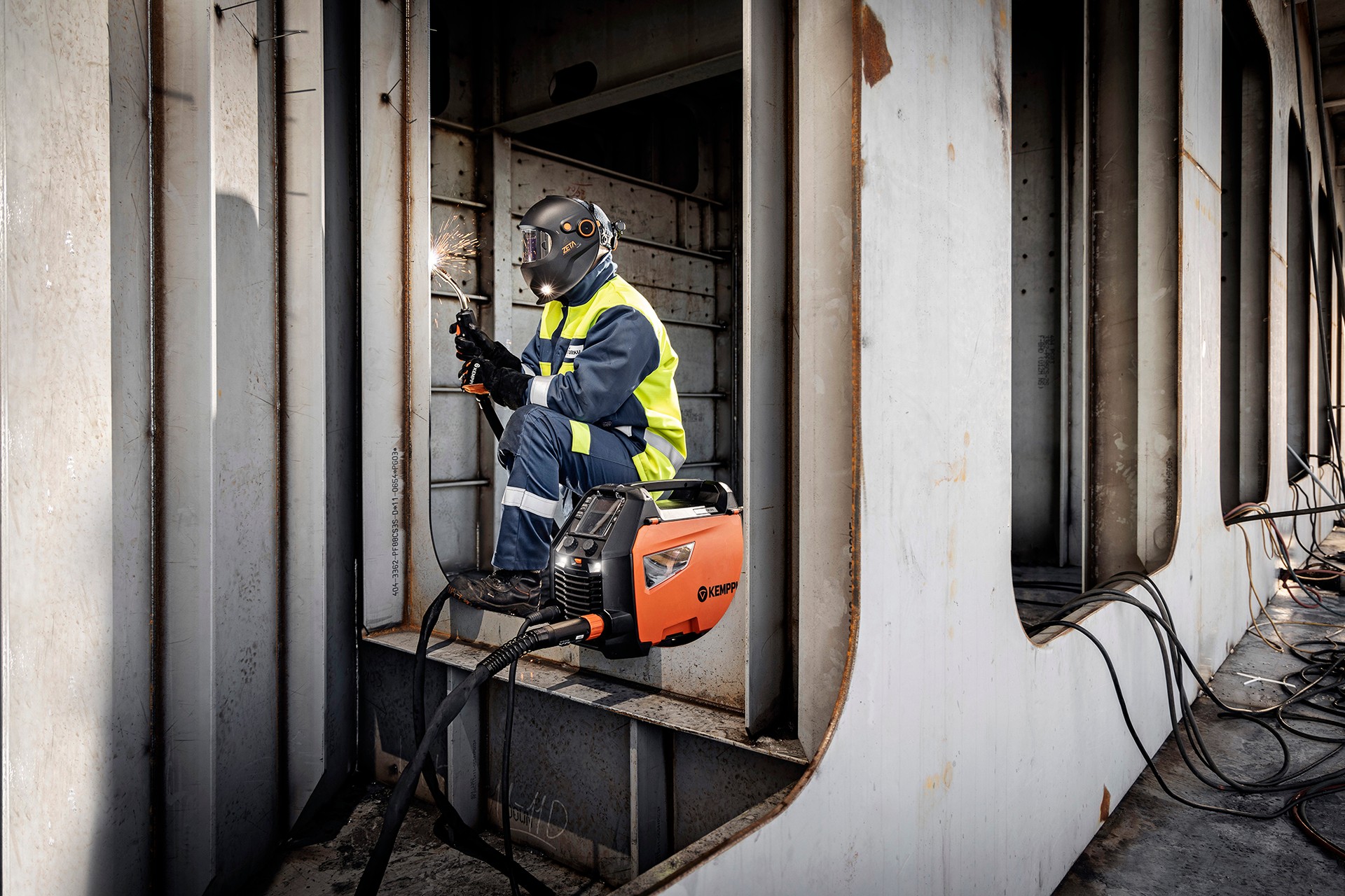 A welder welding in a ship