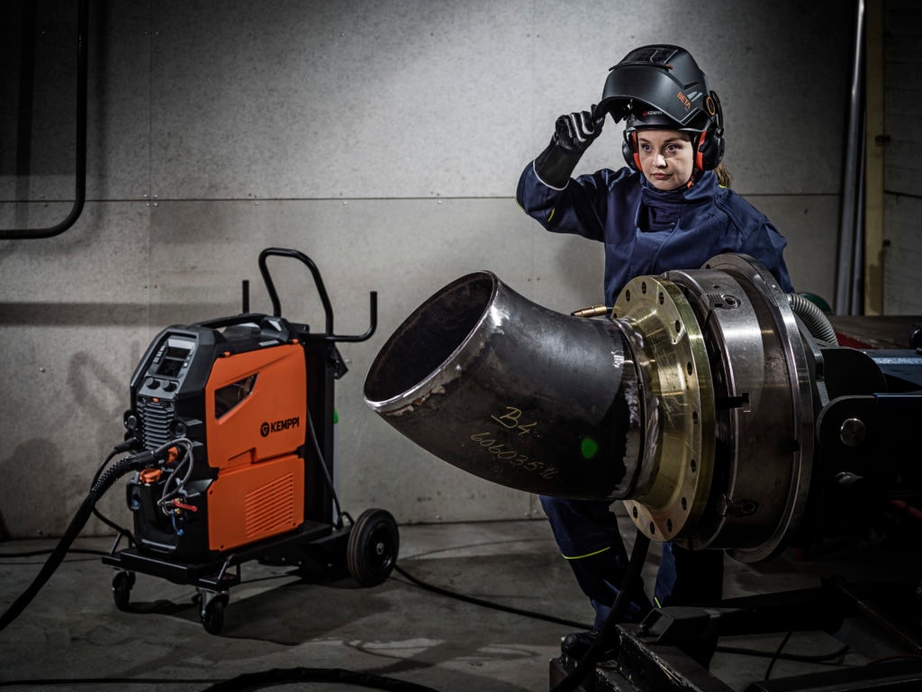 Welder using a hard hat converted to welding shield