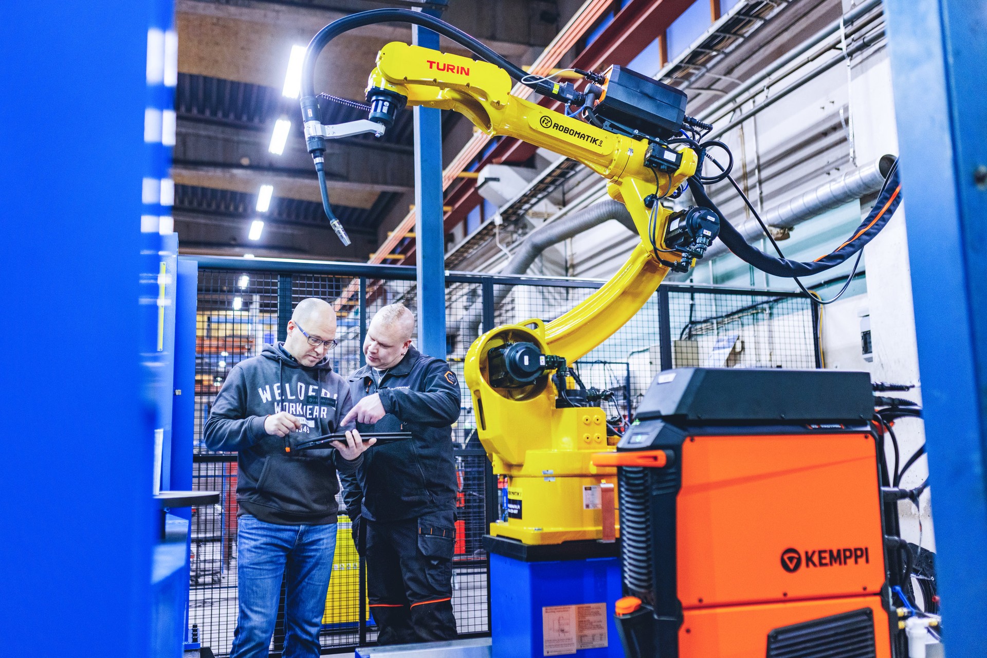 In this photo you can see the integrator together with a Kemppi automation specialist working with a welding robot system.